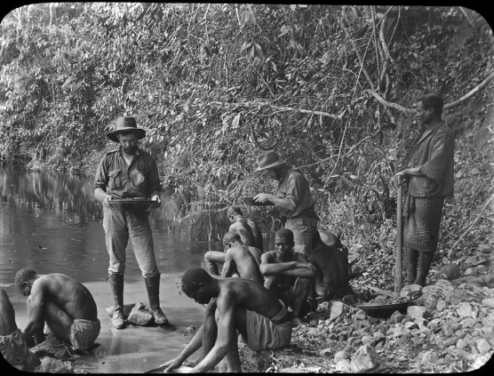 Surveyor and locals panning for gold in alluvial workings